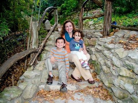 Mom with her son and daughter on a rocky bridge.